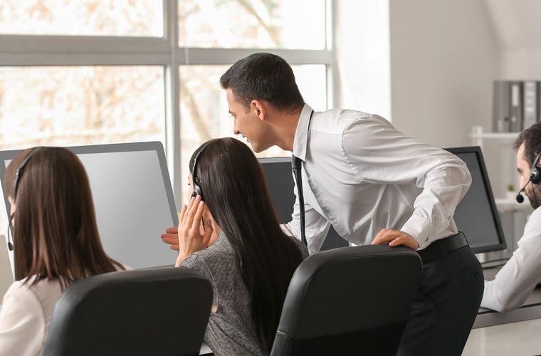 A team working together at computer workstations in an office